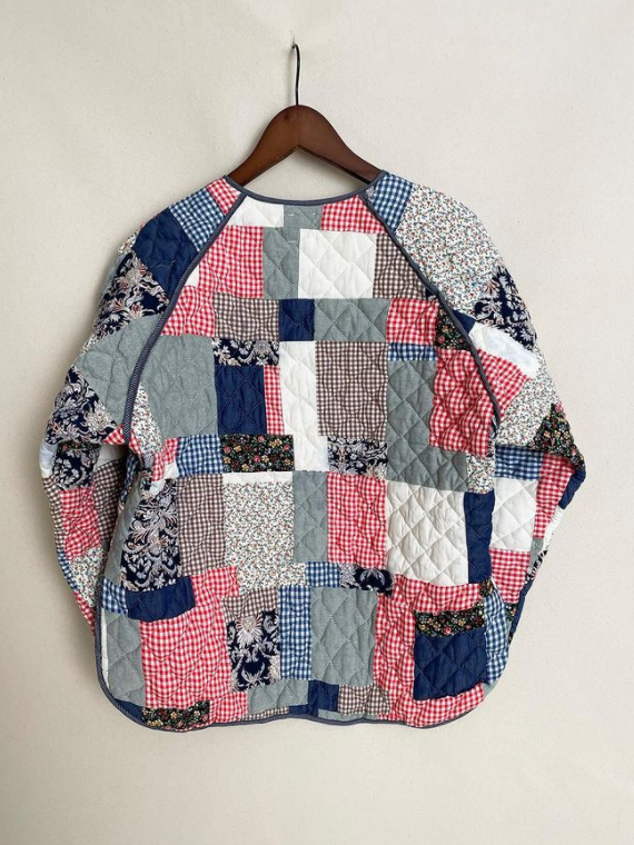 Oversized quilted jacket made from multicolored patchwork fabrics.