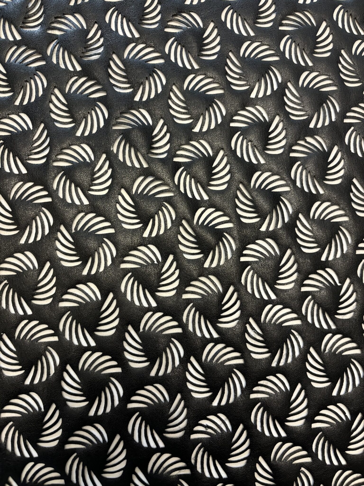 Hand embroidery of abstract organic shapes in bold thread on fabric.