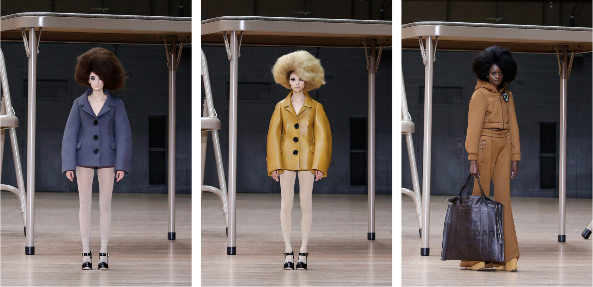 Three runway models wearing oversized coats and textured hair, in grey, mustard yellow, and camel brown tones.