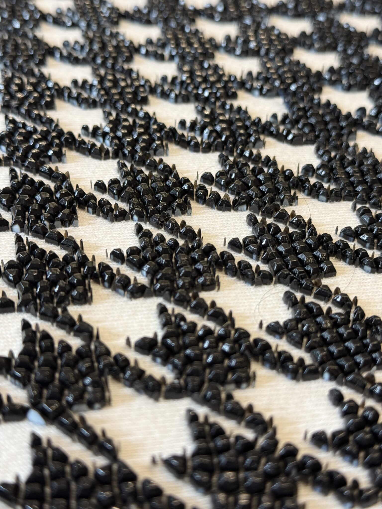 Black beaded embellishment in a houndstooth pattern.
