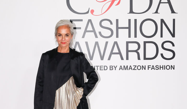 Woman with silver hair poses in two-tone dress at CFDA Awards.