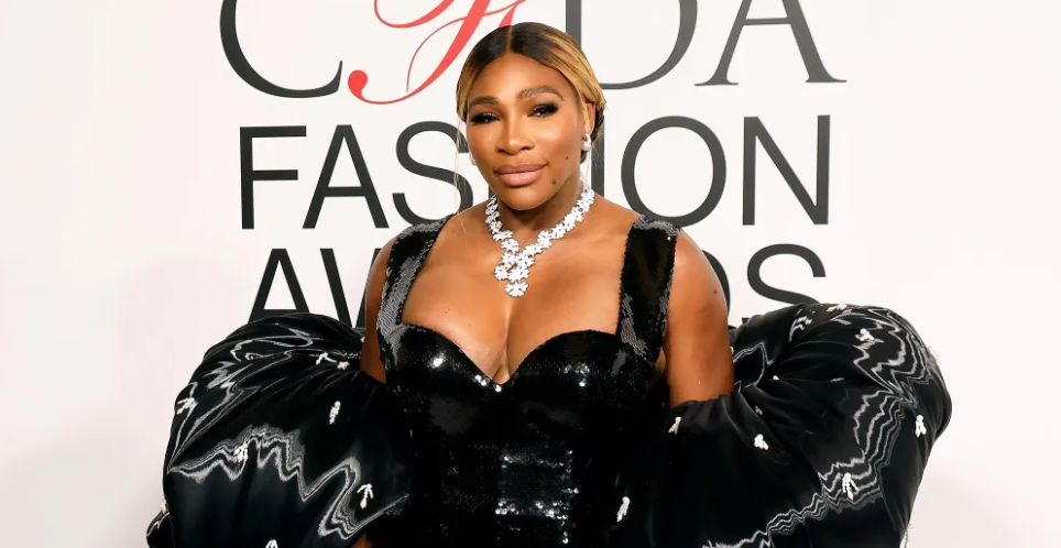 Serena Williams in dramatic black gown with oversized sleeves and diamonds.