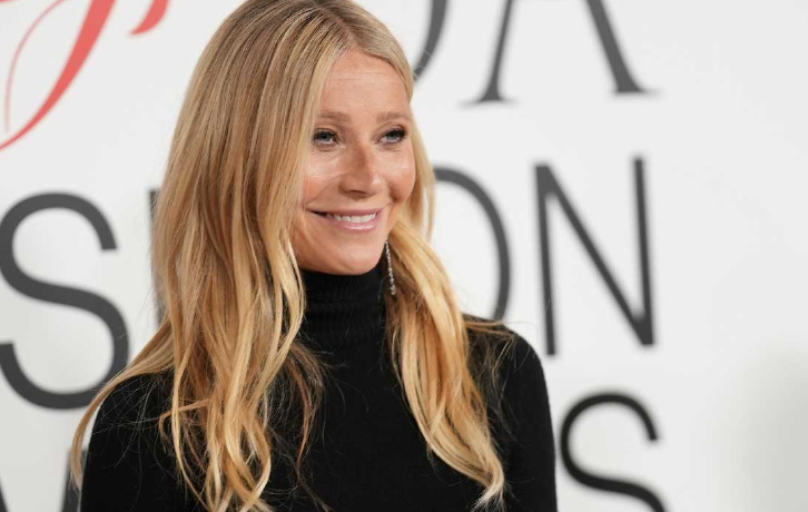 Gwyneth Paltrow smiling in a black turtleneck at the CFDA Fashion Awards.