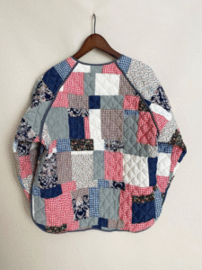 Oversized quilted jacket made from multicolored patchwork fabrics.