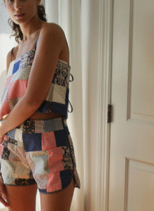 Woman wearing a patchwork top and shorts set.