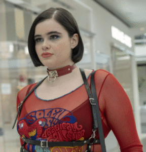 Woman wearing a bold red mesh top with gothic accessories in a mall setting.