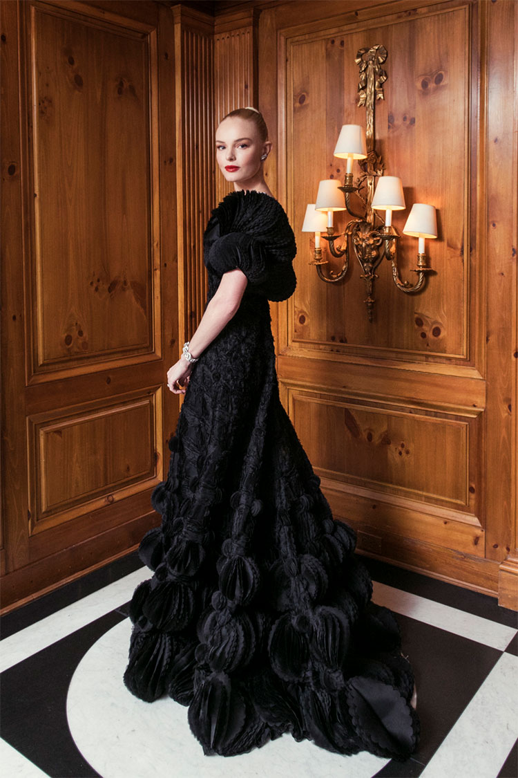 Kate Bosworth at the Met Gala wearing a dramatic black dress with puffed sleeves and detailed texture.
