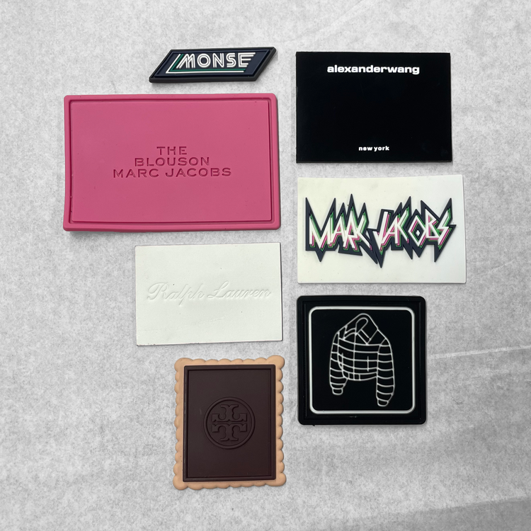 Group of rubber labels from designers like Marc Jacobs, Monse, and Alexander Wang.