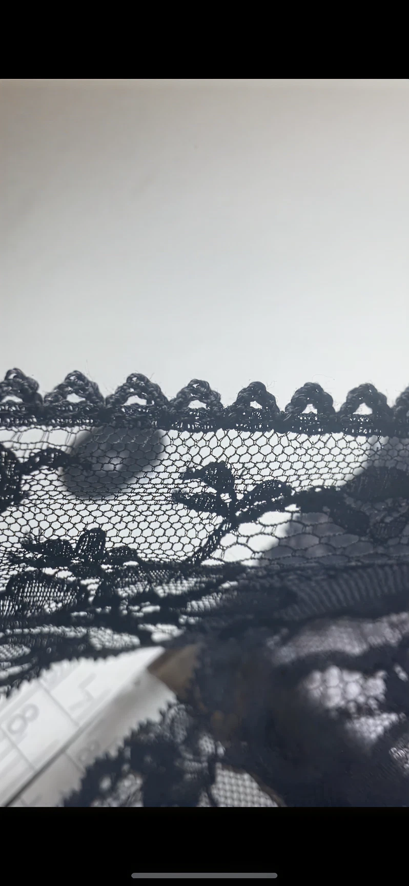 Black floral lace with scalloped edges.