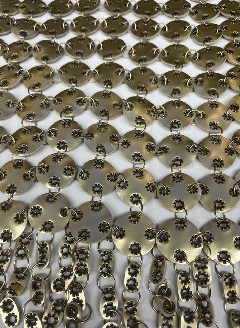 Metallic mirrored sequins embroidered in geometric grid with beads.