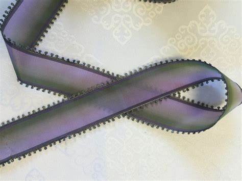 Purple iridescent zipper tape on decorative background.