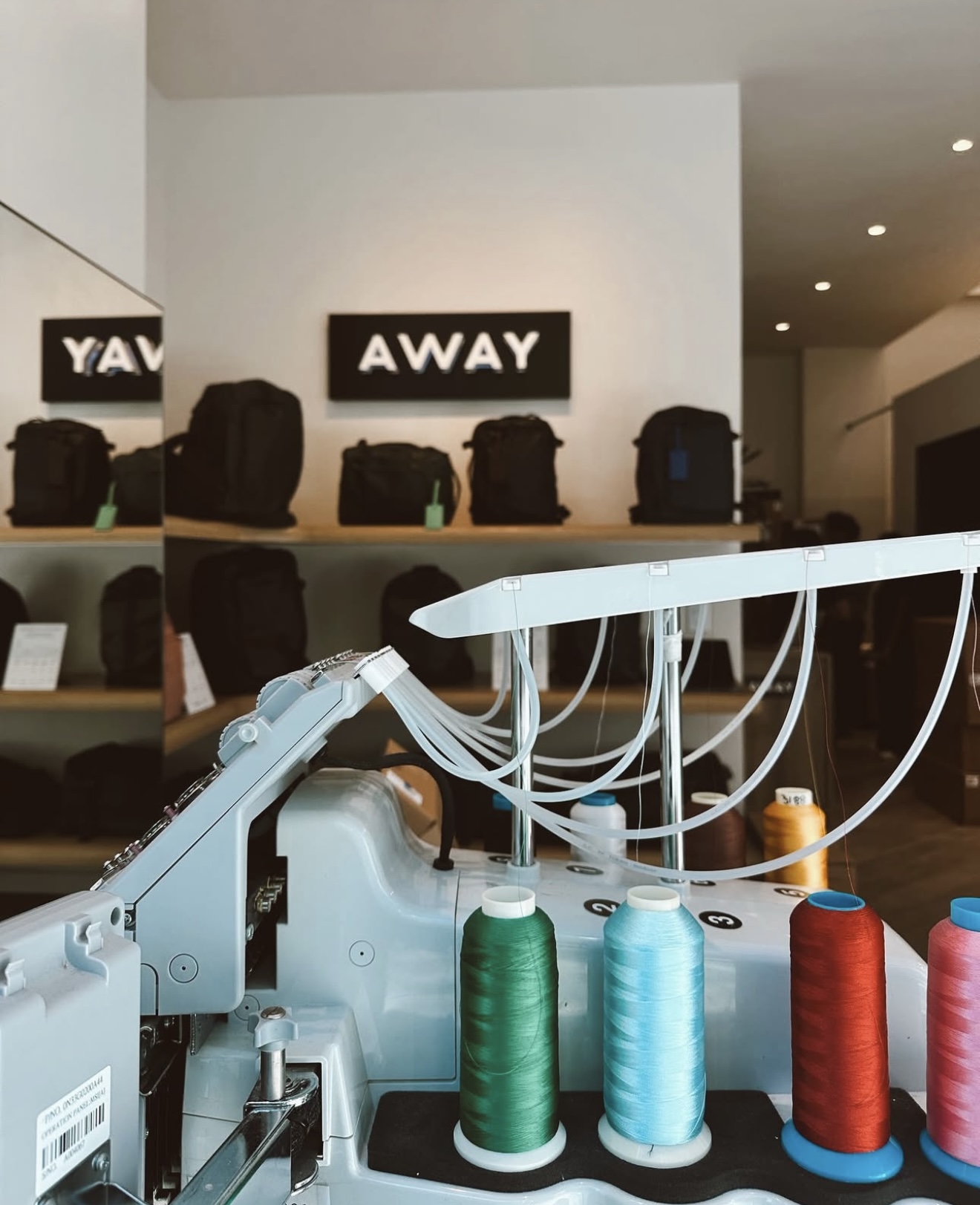 Interior shot of the AWAY retail store displaying suitcases and bags.