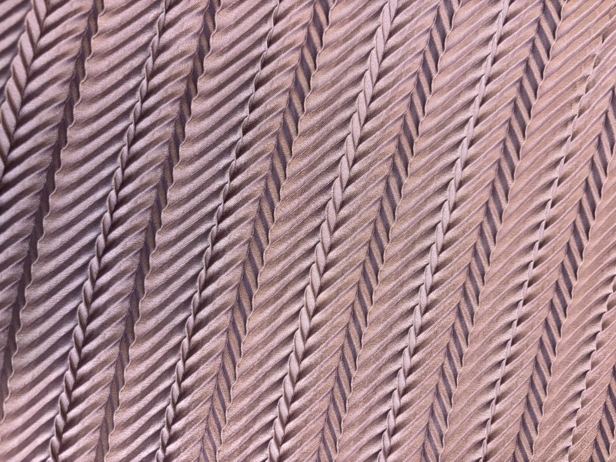 Diagonal rows of dusty rose corded trim.