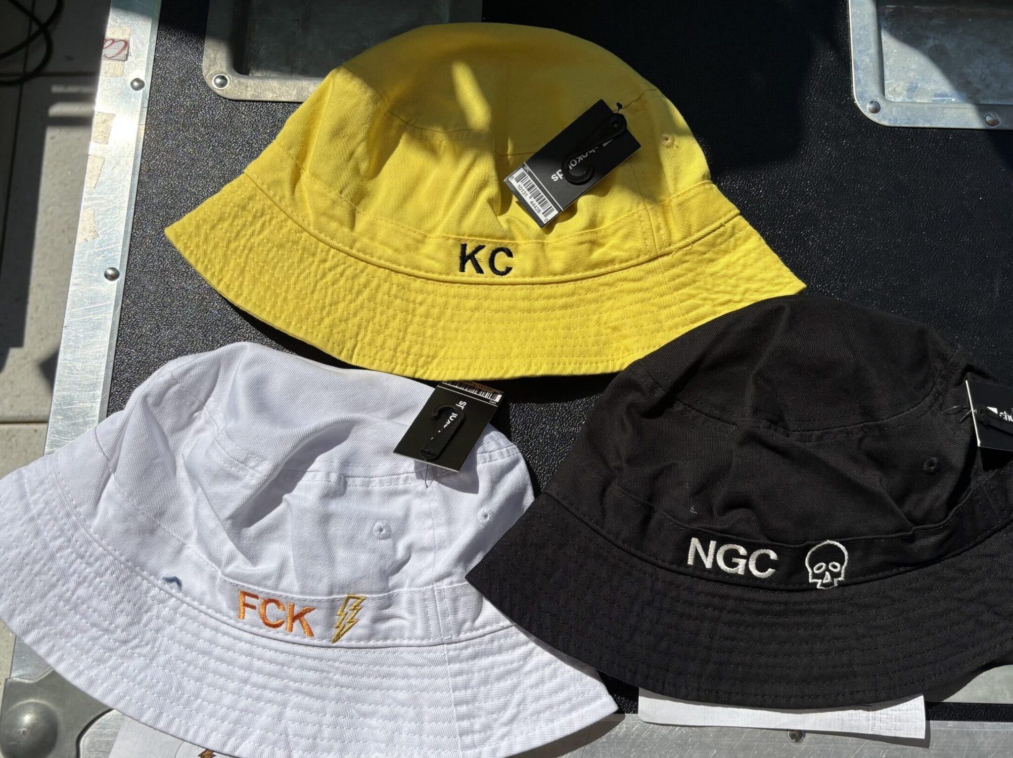 yellow, black, and white bucket hat embroidery - customization on-site