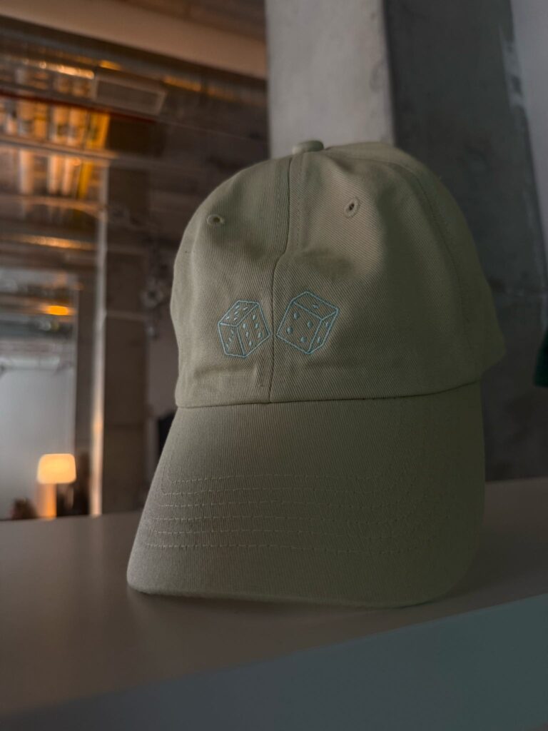 Custom embroidered hats displayed for guests at the Avia event.