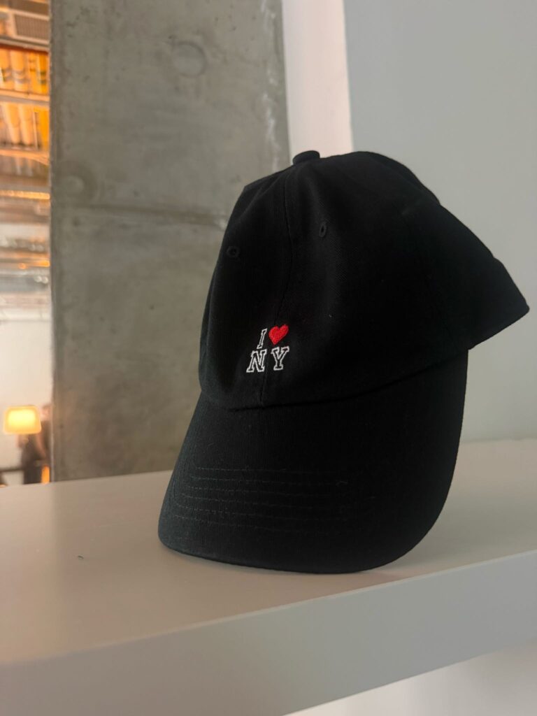 Custom embroidered hats displayed for guests at the Avia event.