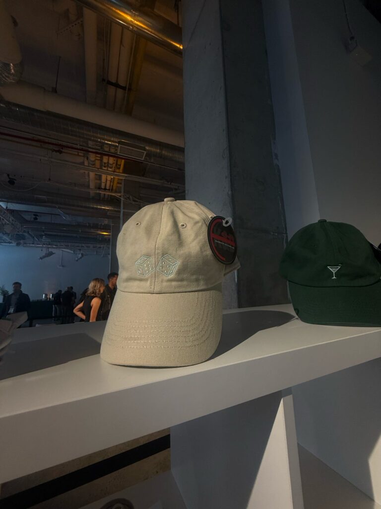 Custom embroidered hats displayed for guests at the Avia event.