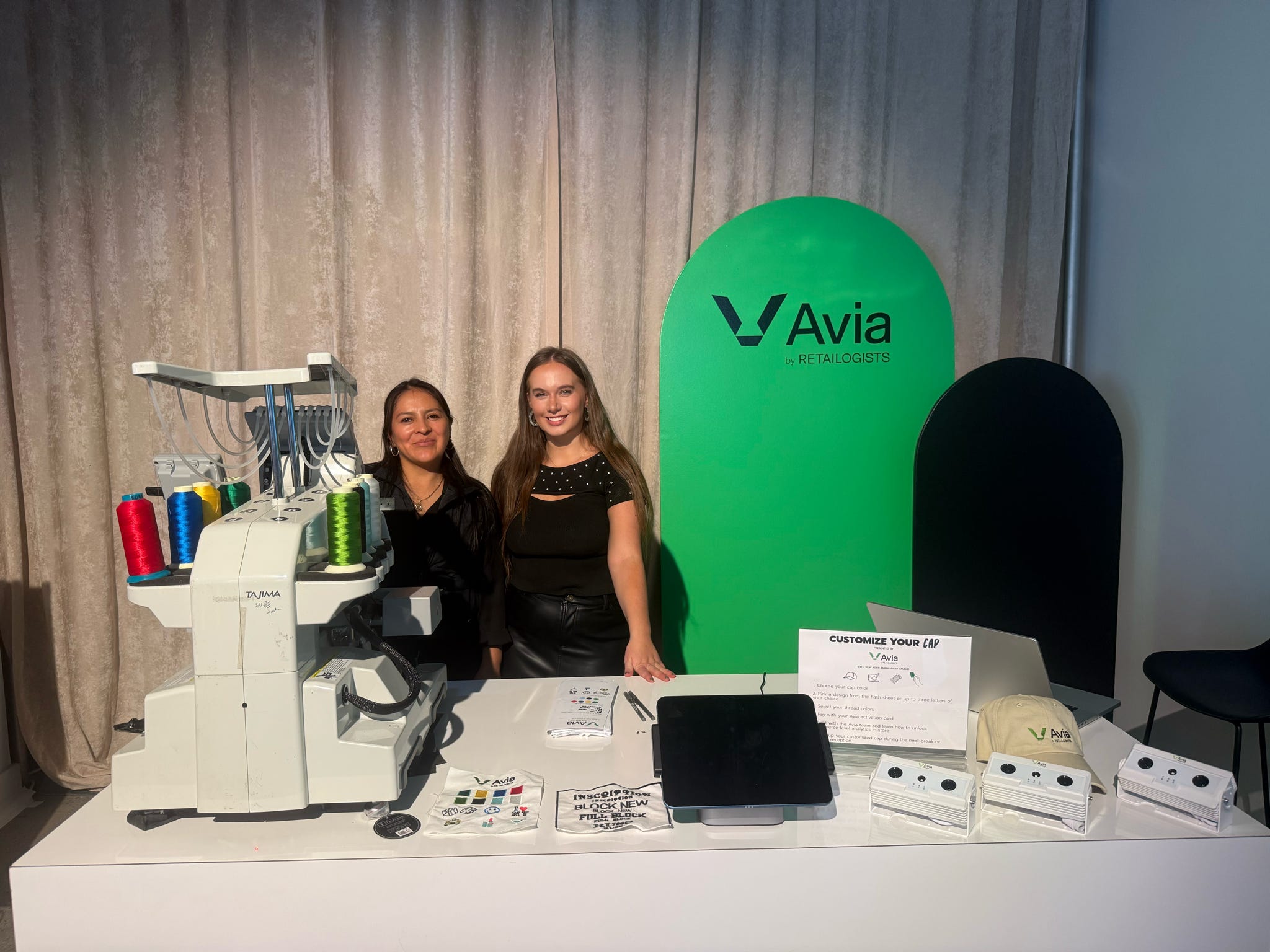 Custom embroidered hats displayed for guests at the Avia event.