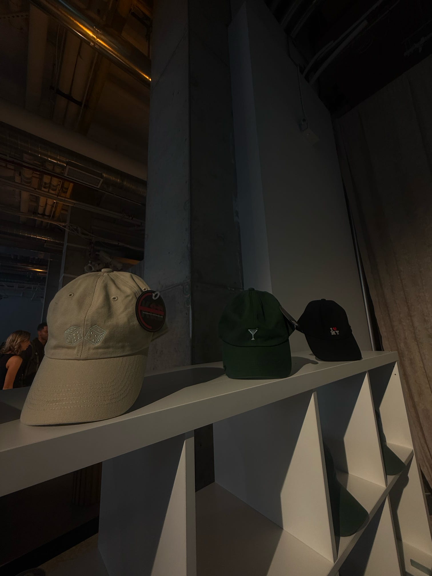 Custom embroidered hats displayed for guests at the Avia event.