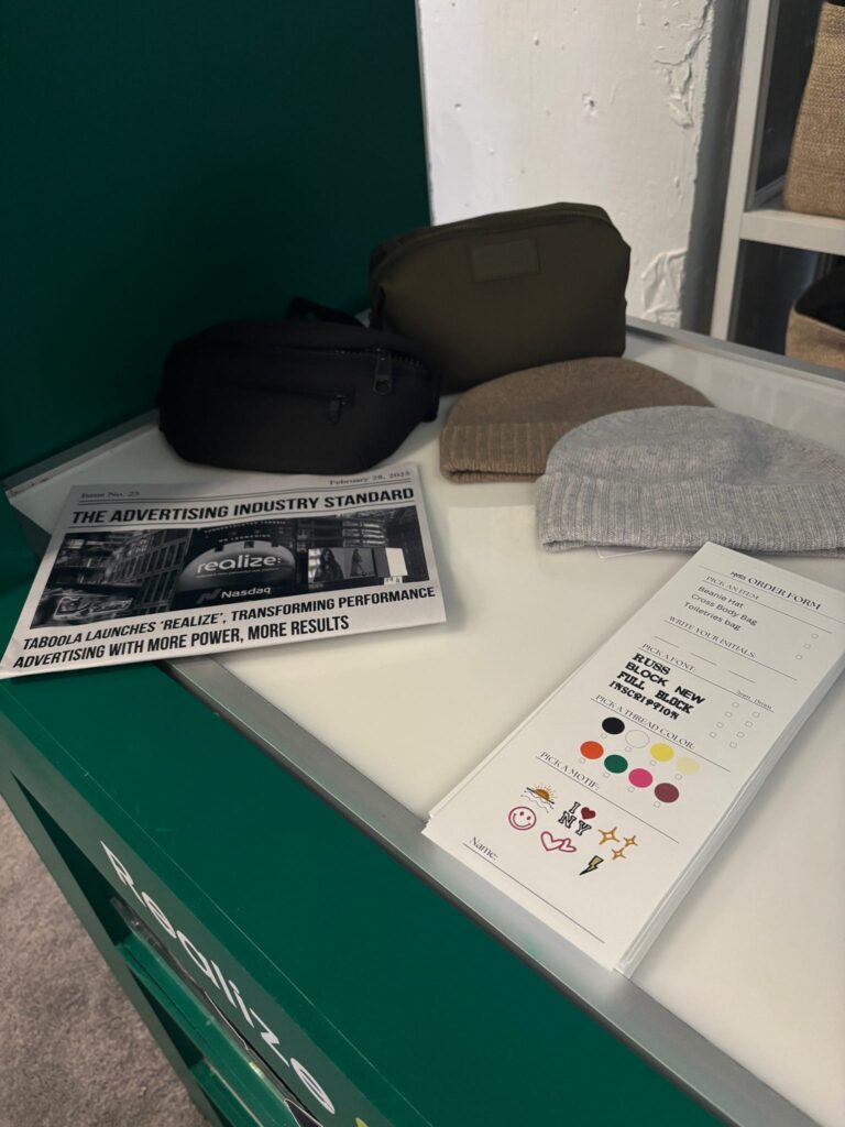 Guests having their Dagne Dover pouches custom embroidered live at the Taboola event.