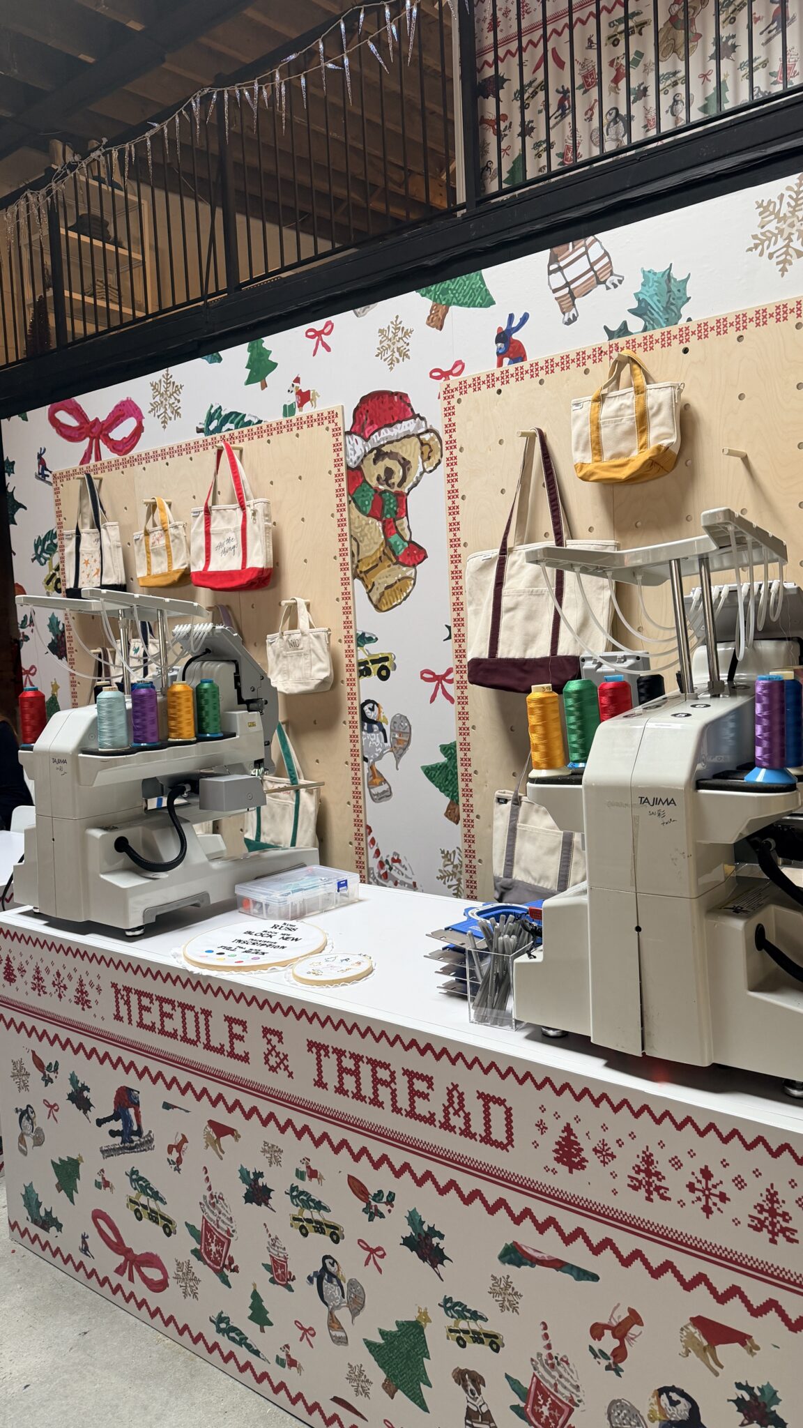 Embroidered totes and sweaters featuring personalized names, initials, and holiday motifs created by New York Embroidery Studio for live event customization.