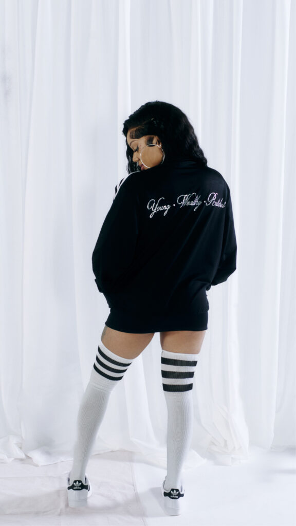 Close-up of hot fix crystal lettering applied to a black athletic jacket