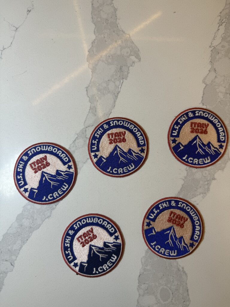 J.Crew U.S. Ski embroidered patches arranged on work surface, showcasing detailed stitching and bold colors