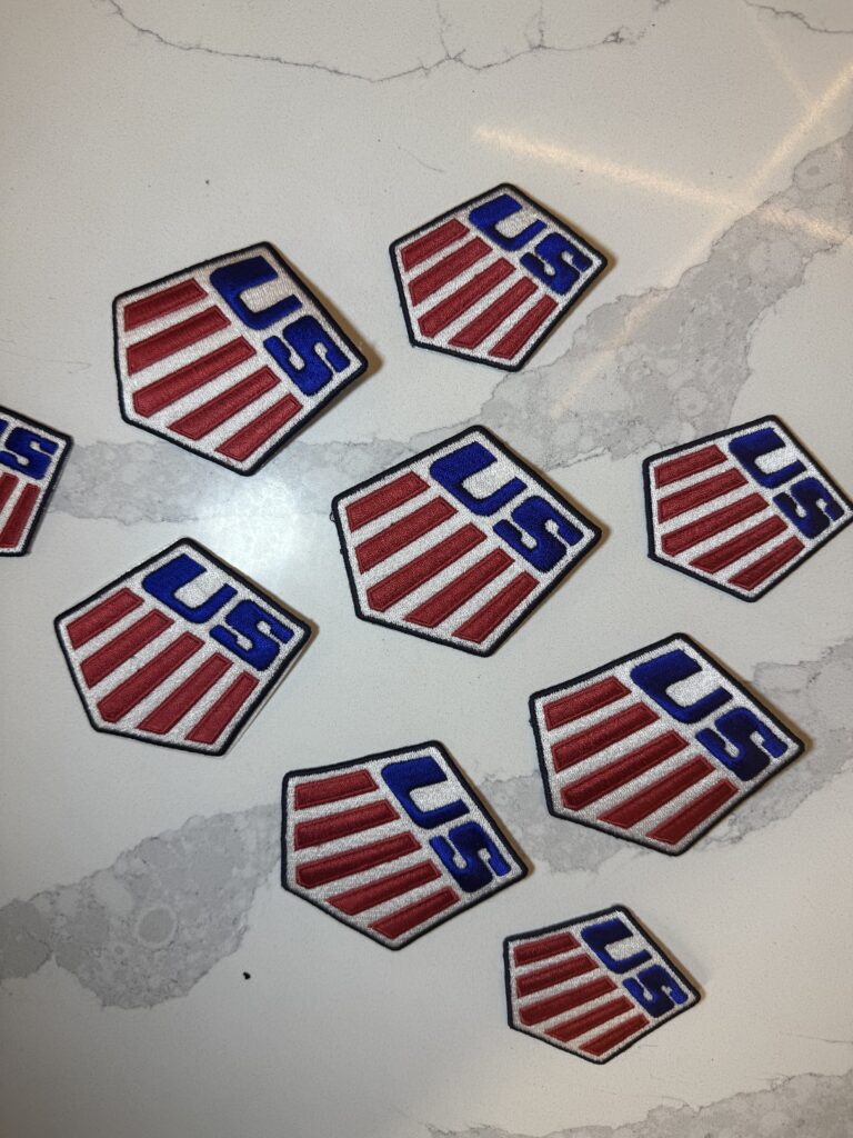 J.Crew U.S. Ski embroidered patches arranged on work surface, showcasing detailed stitching and bold colors
