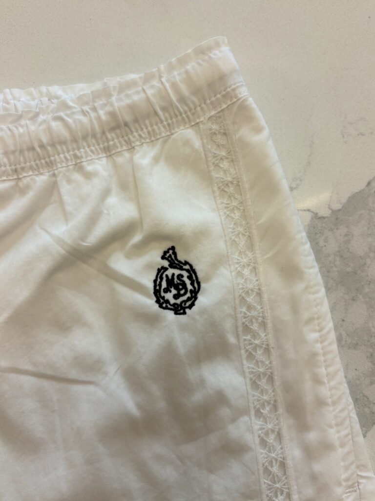 White shorts featuring lace trim and embroidered J.Crew patch detail
