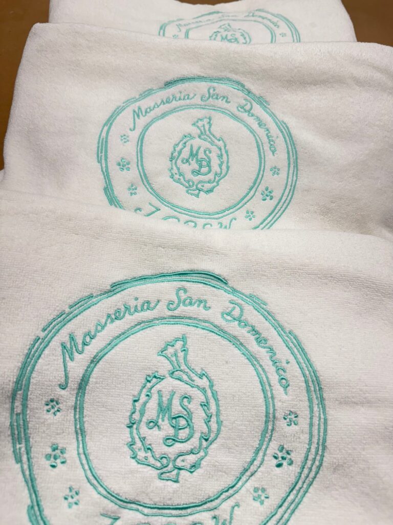 Stack of towels embroidered with custom J.Crew crest design