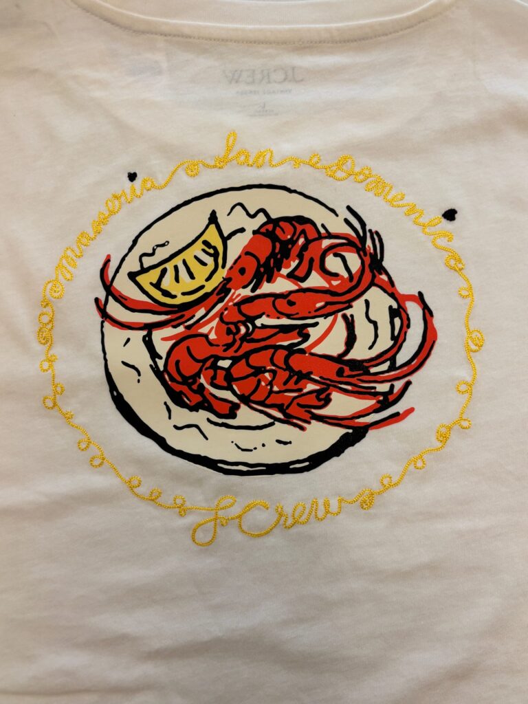 Embroidered graphic artwork on a J.Crew t-shirt featuring multicolor stitching