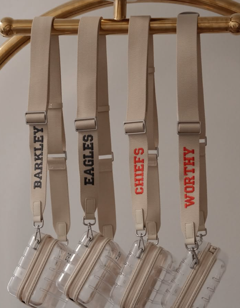 Beige fabric straps embroidered with names and team references for AWAY Super Bowl personalization