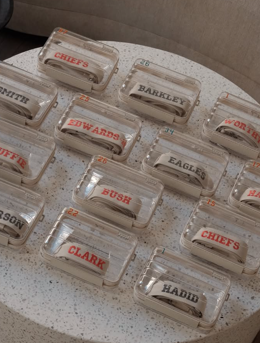 ransparent AWAY travel cases featuring custom embroidered name straps created for a Super Bowl brand activation