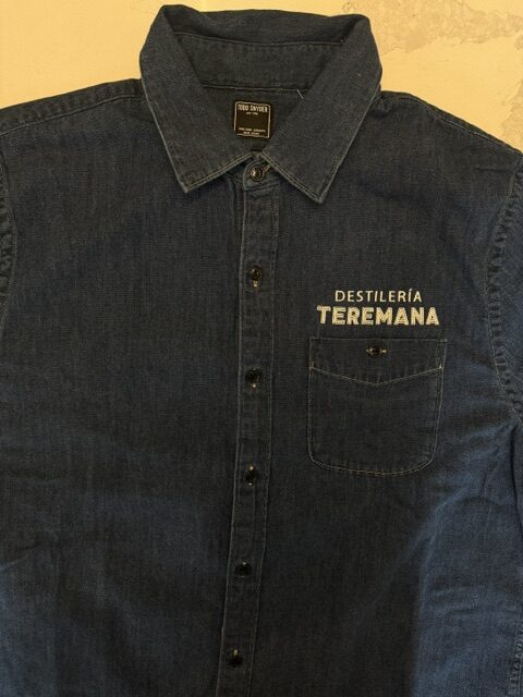 Embroidered Destilería Teremana logo stitched on denim button-down shirt