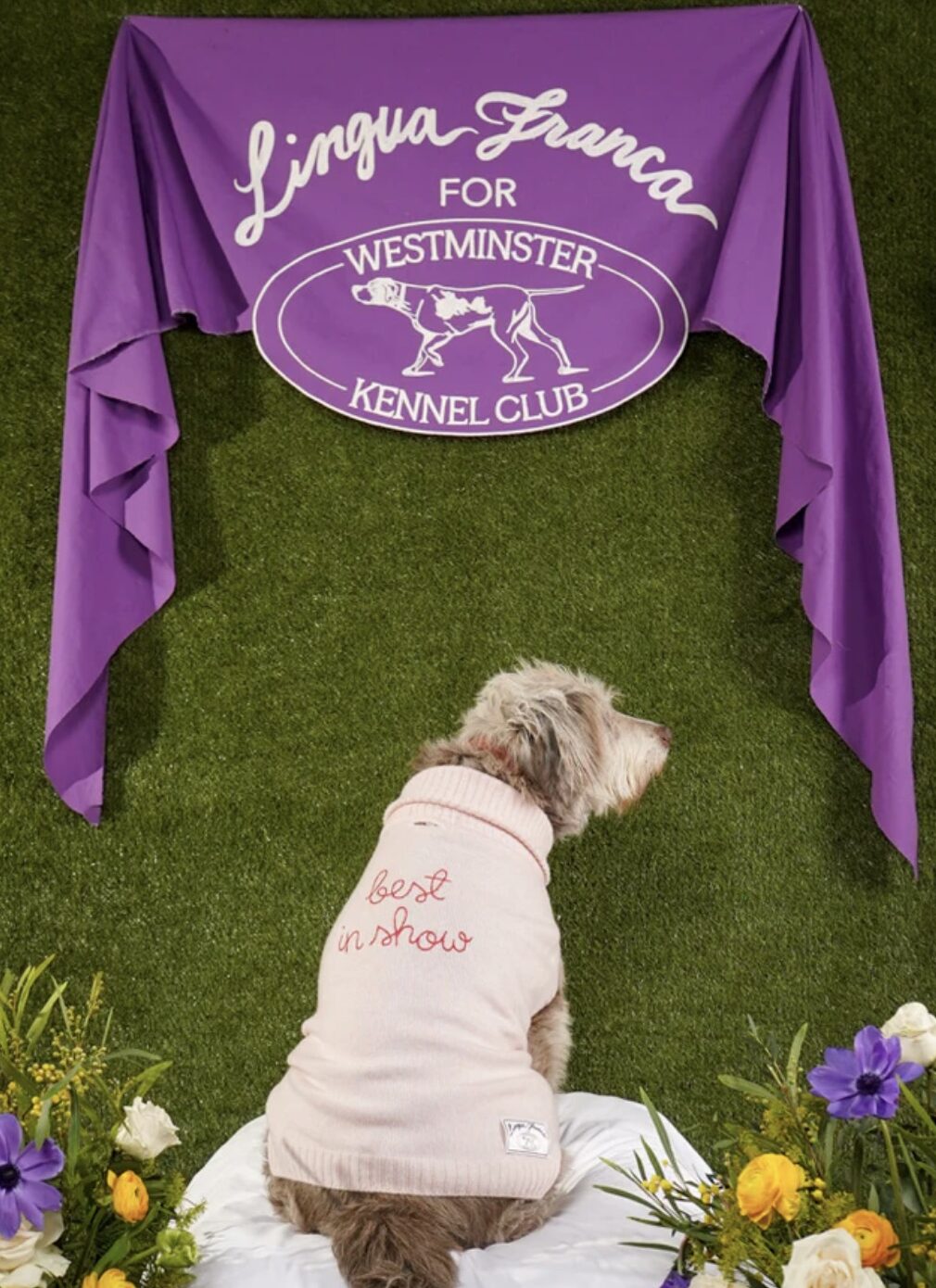 Chain stitch embroidery in white thread executed at scale for a custom event banner.