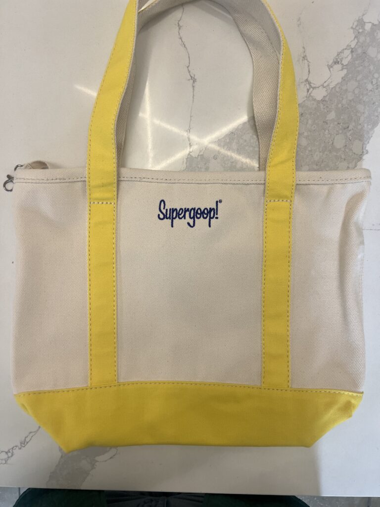 Canvas tote bag featuring custom embroidered Supergoop! logo with blue accents
