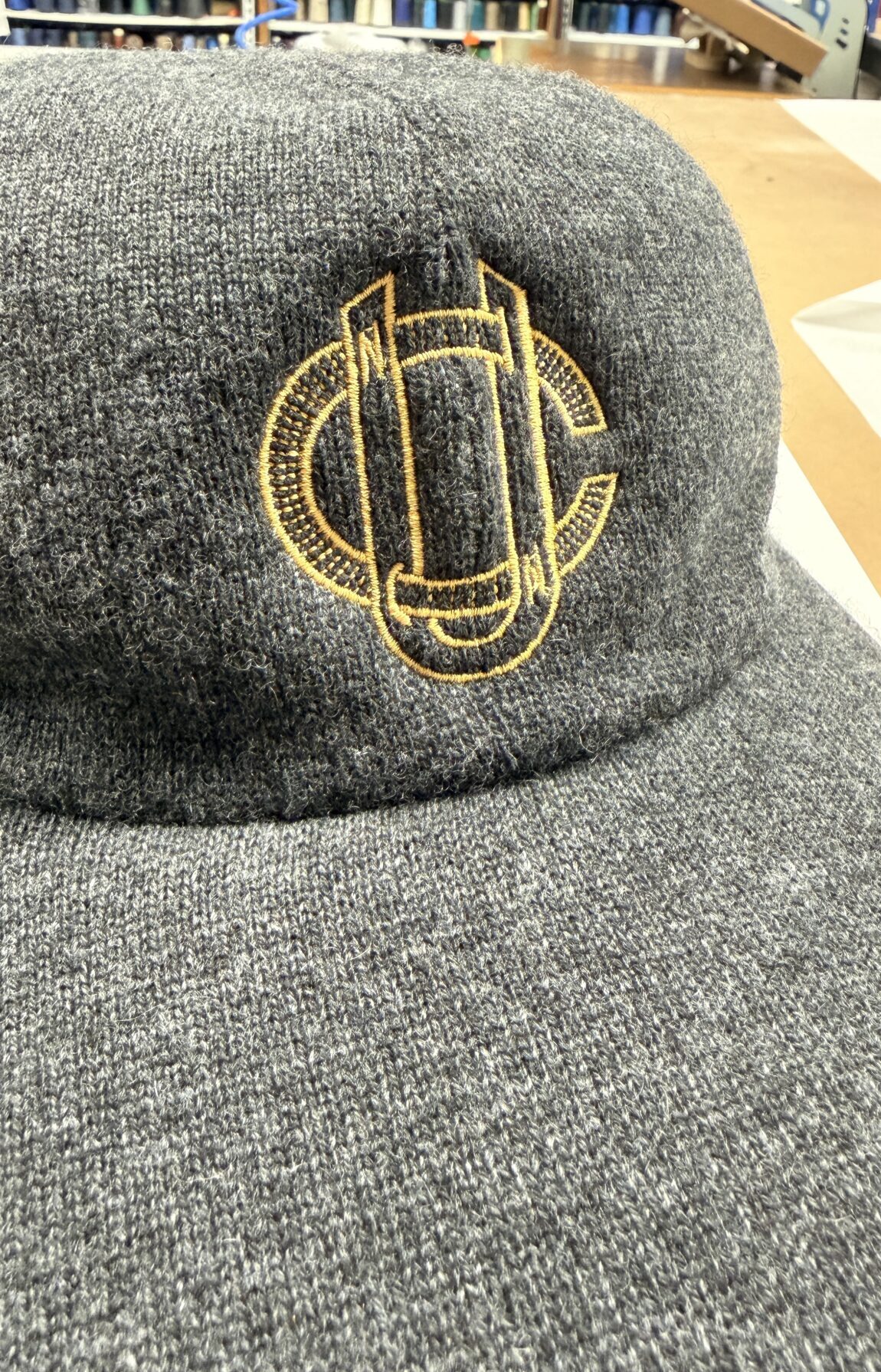 Wool baseball cap featuring gold embroidered crest on front panel