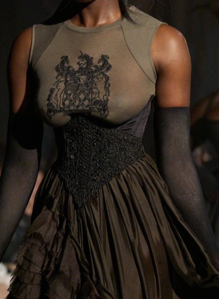 Couture dress featuring an embellished bodice with graphic motif and hand-applied beaded waist detailing