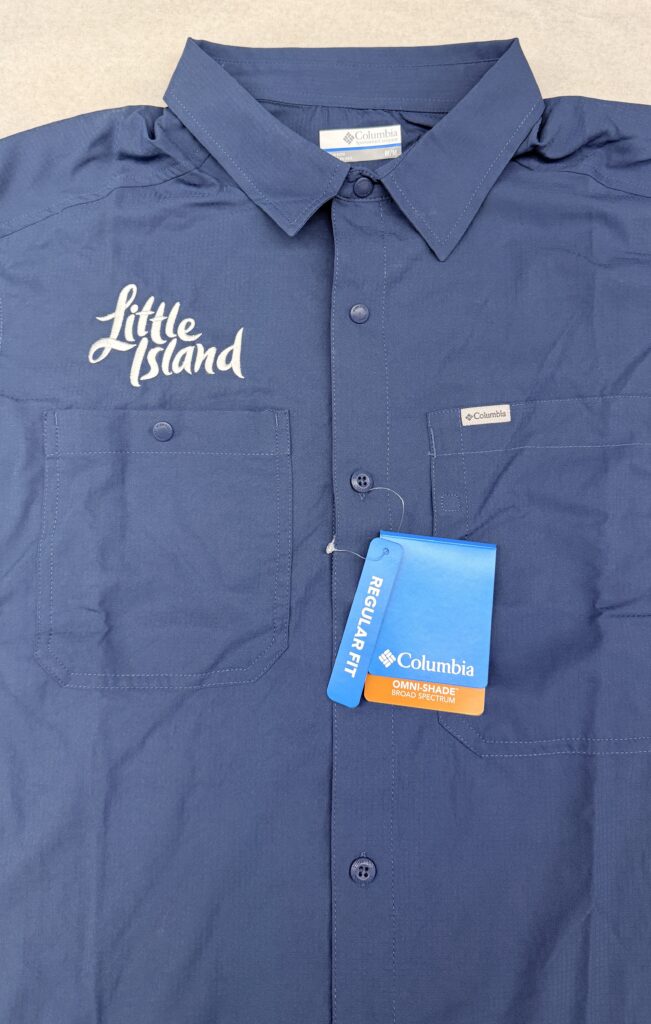 hite embroidered Little Island logo on teal and navy Columbia Sportswear performance uniforms for the brand's staff apparel refresh.