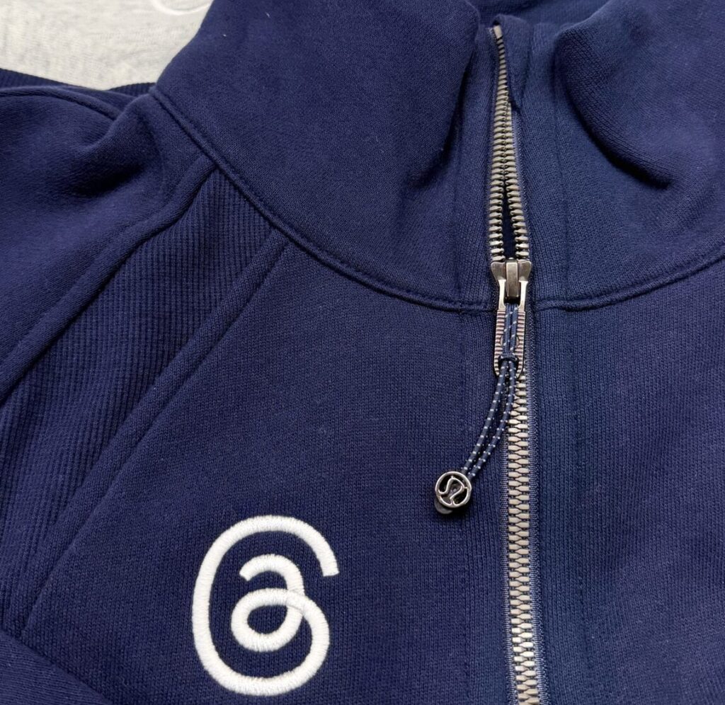 Threads logo applied with custom performance apparel embroidery onto Lululemon base jackets.