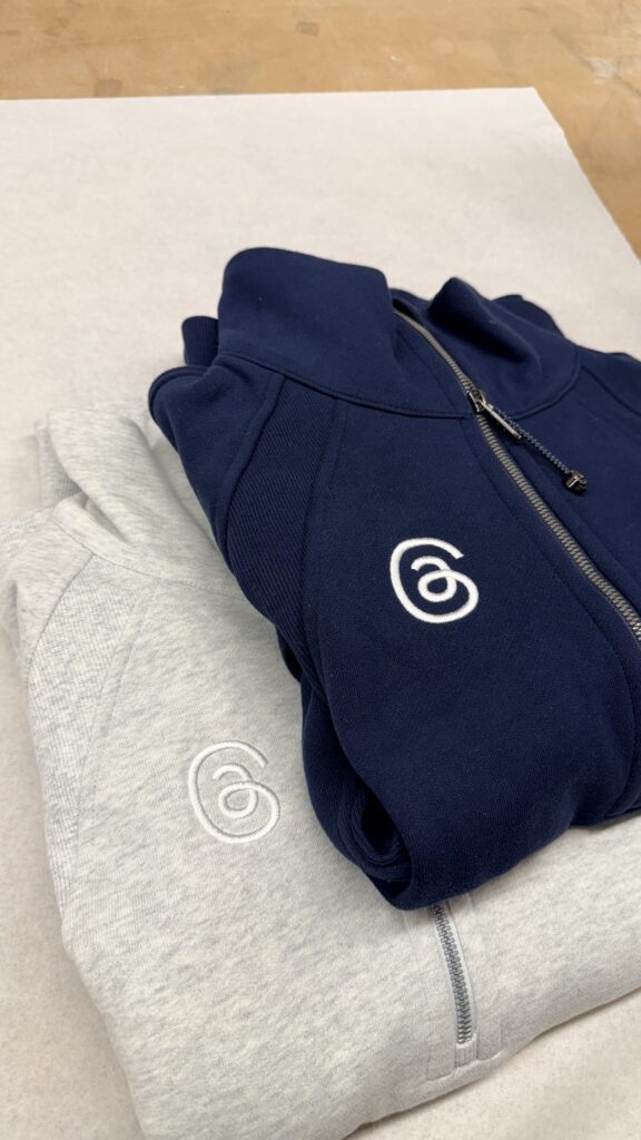 Threads logo applied with custom performance apparel embroidery onto Lululemon base jackets.