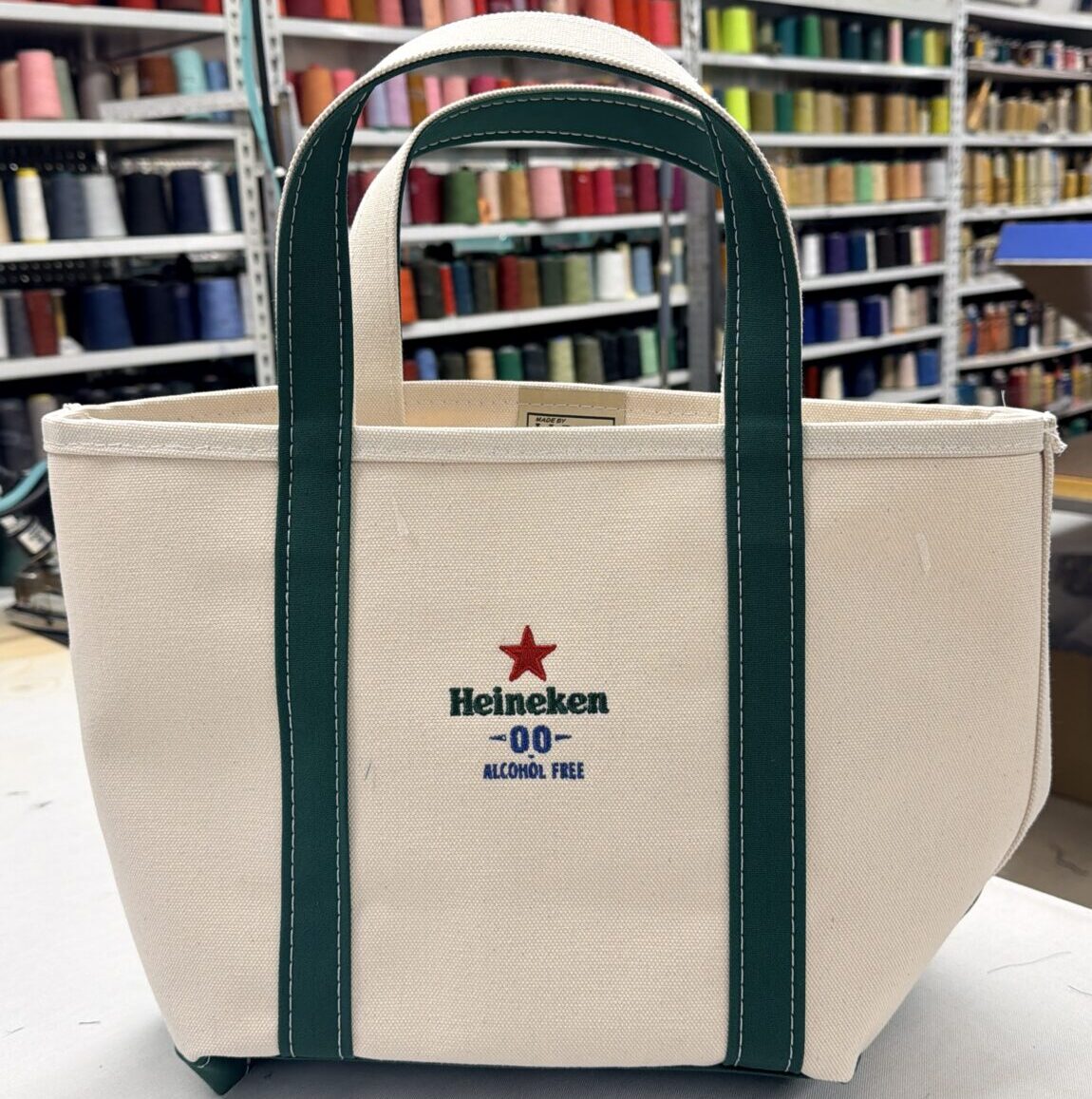Custom embroidered Heineken 0.0 logo on canvas L.L.Bean Boat and Tote bag produced by New York Embroidery Studio