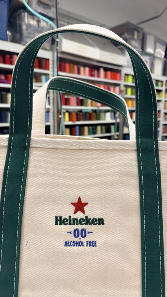 Custom embroidered Heineken 0.0 logo on canvas L.L.Bean Boat and Tote bag produced by New York Embroidery Studio