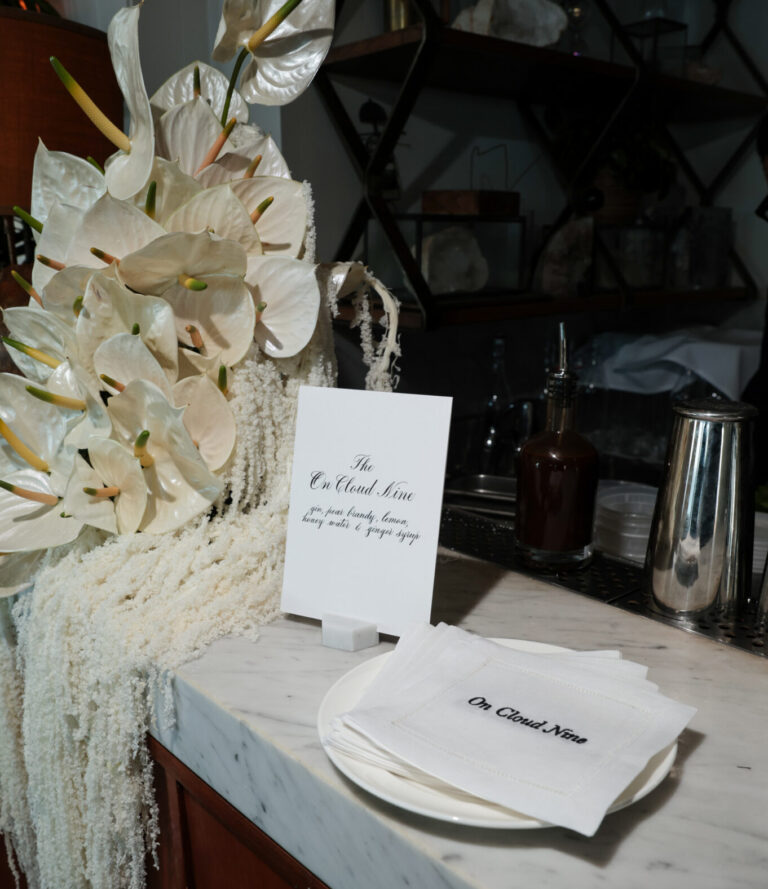 Custom embroidered linen napkins with calligraphy menu and place card at Intimissimi Ultralight Cotton Collection event in Los Angeles