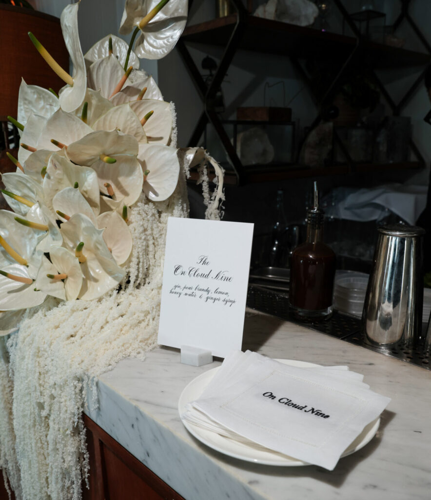 Custom embroidered linen napkins with calligraphy menu and place card at Intimissimi Ultralight Cotton Collection event in Los Angeles