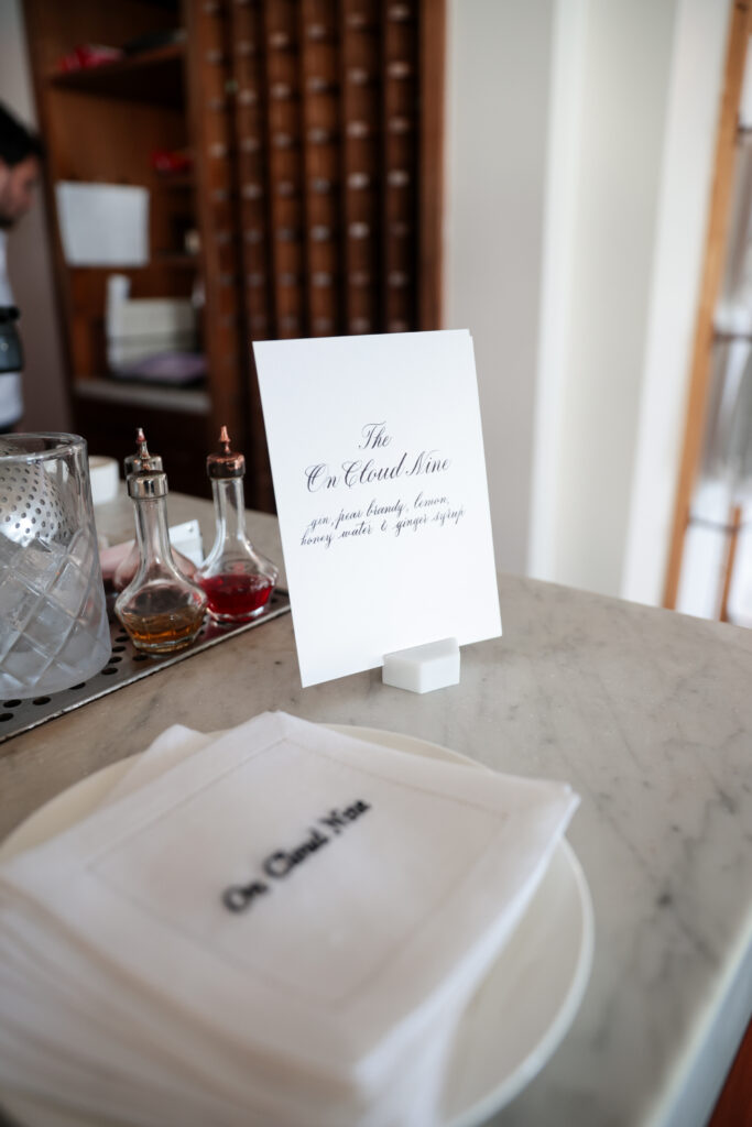 Custom embroidered linen napkins with calligraphy menu and place card at Intimissimi Ultralight Cotton Collection event in Los Angeles