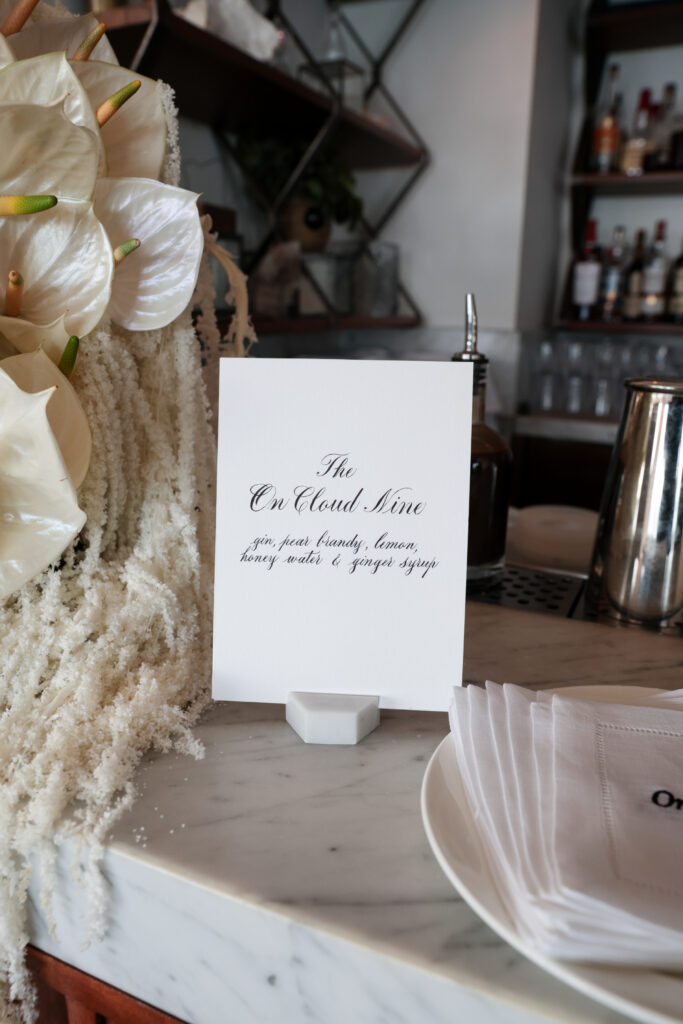 Custom embroidered linen napkins with calligraphy menu and place card at Intimissimi Ultralight Cotton Collection event in Los Angeles