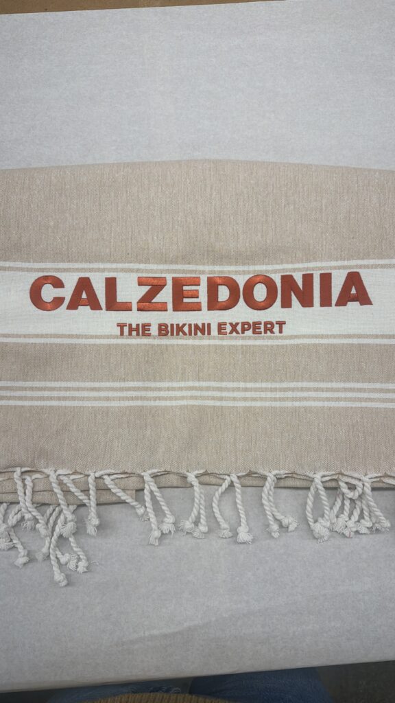 Custom embroidered Calzedonia towels displayed at Soho Beach House Miami event