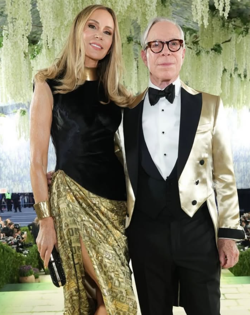 Dee Ocleppo Hilfiger at the 2026 Met Gala wearing a custom Tommy Hilfiger and Joel Jolibe gold gown inspired by Gustav Klimt’s Portrait of Adele Bloch-Bauer I. The dress features layers of gold crystals, foil, and intricate hand-beading.