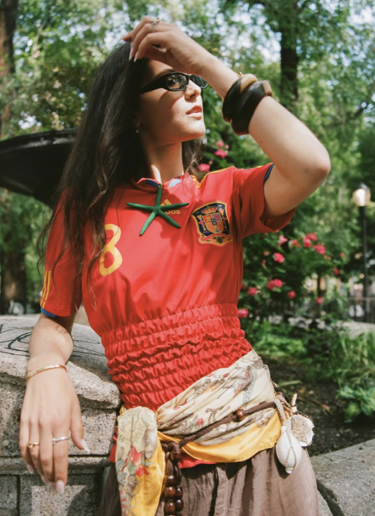 A complete one-of-one designer soccer jersey reconstructed from a vintage kit featuring custom hand-smocked panel detailing.